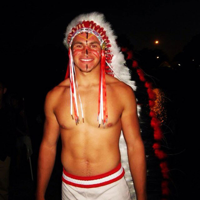 Senior Sean Bernard led the football team at the bonfire, wearing the traditional headdress.