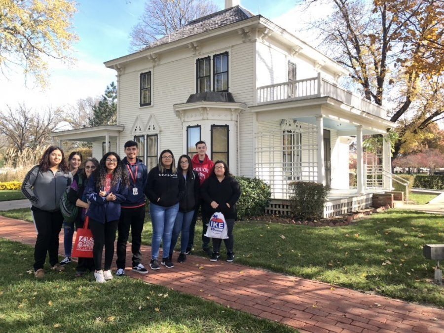 History Club poses next to former President Eisenhowers childhood home while visiting the Eisenhower Presidential Library Museum in Abilene, Kansas.
