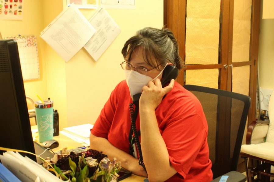 School Nurse Carmina Suter answers another phone call during her busy school day.