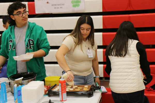 Sophomore Briana Lopez prepares her mini pancakes that she sold at Market Day.