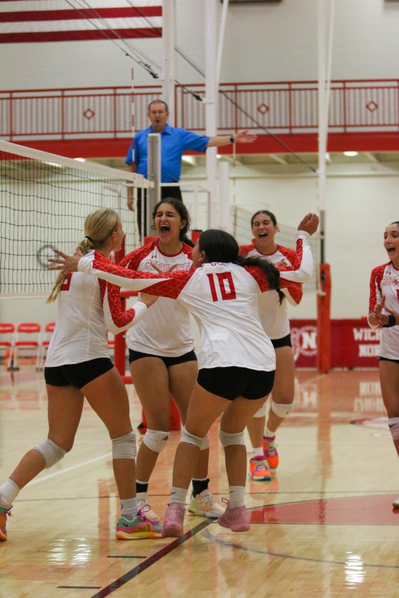 The volleyball team celebrates scoring a point in their match against Southeast.