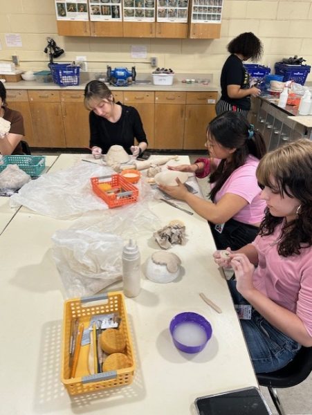 Students in Tina Thomas' pottery class work on creating bowls for the "Empty Bowls" fundraiser.