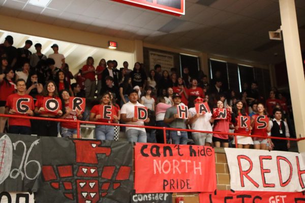 Juniors show off their signs at the fall sports pep assembly.