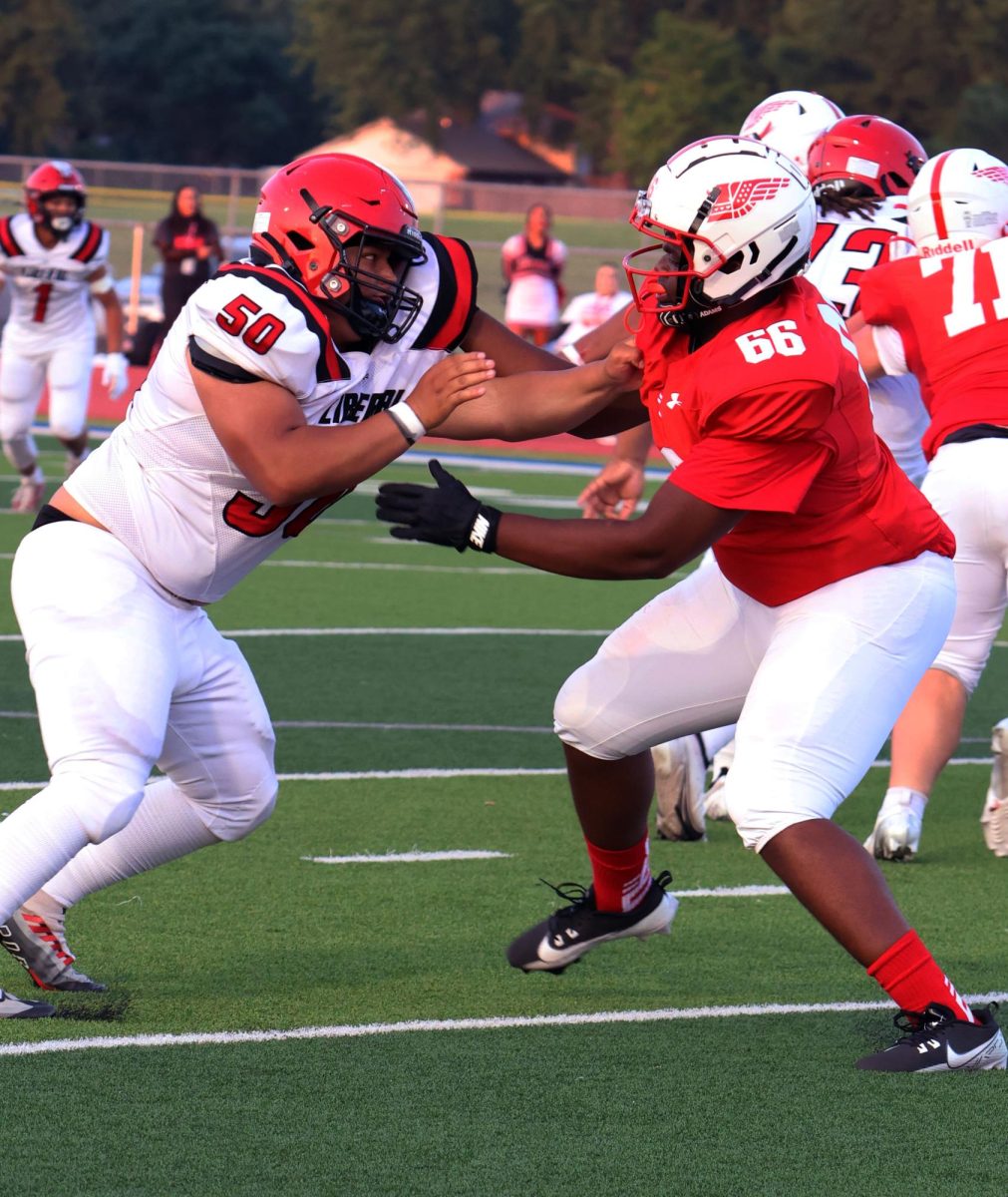 Senior Mario Jackson attempts to block the defensive end from Liberal.