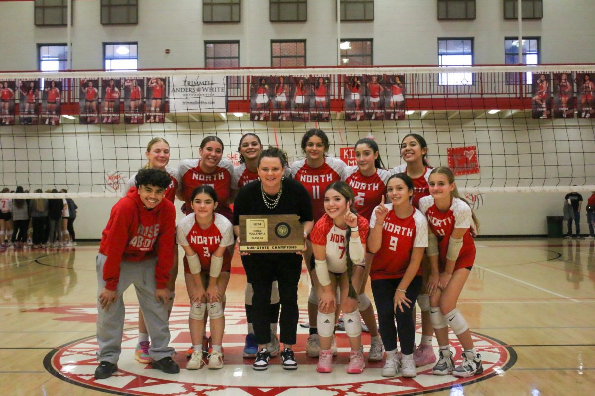 The volleyball team gather for a team photo after winning sub state.