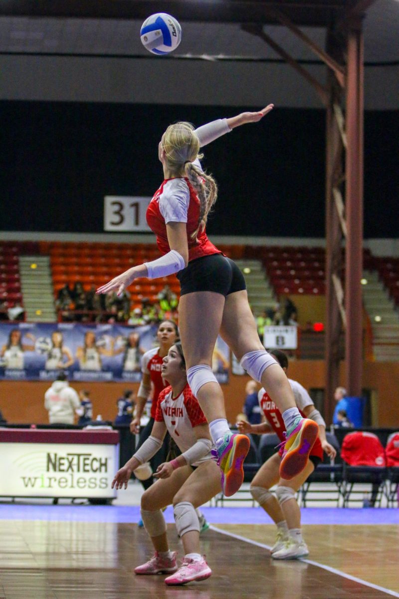 Senior Tori Buss skies for a kill against Blue Valley West.