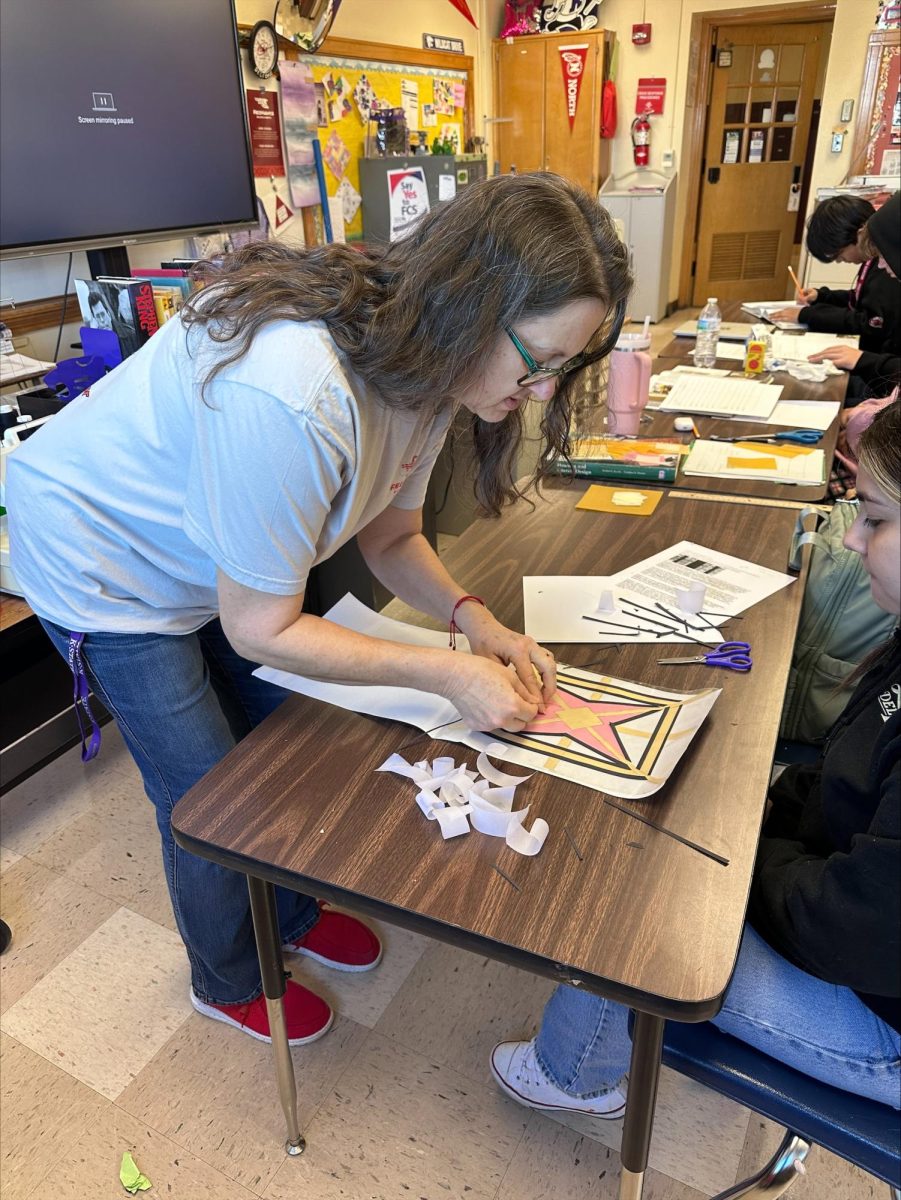 Aileen Delforge helps students in her FACS class. Delforge is retiring at the end of the school year.