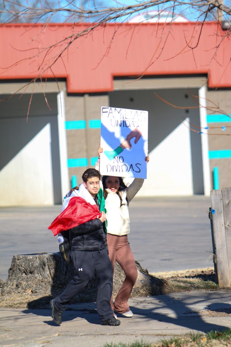 North students hold up signs in a protest focused on Immigration and Customs Enforcement.